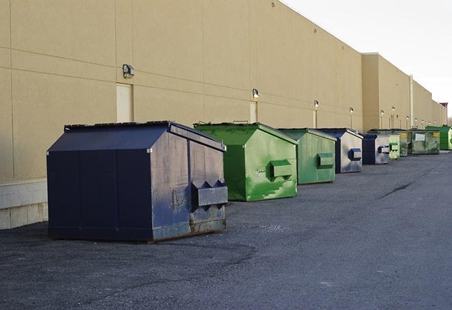 tilted front-load dumpsters being emptied by waste management workers in Florence